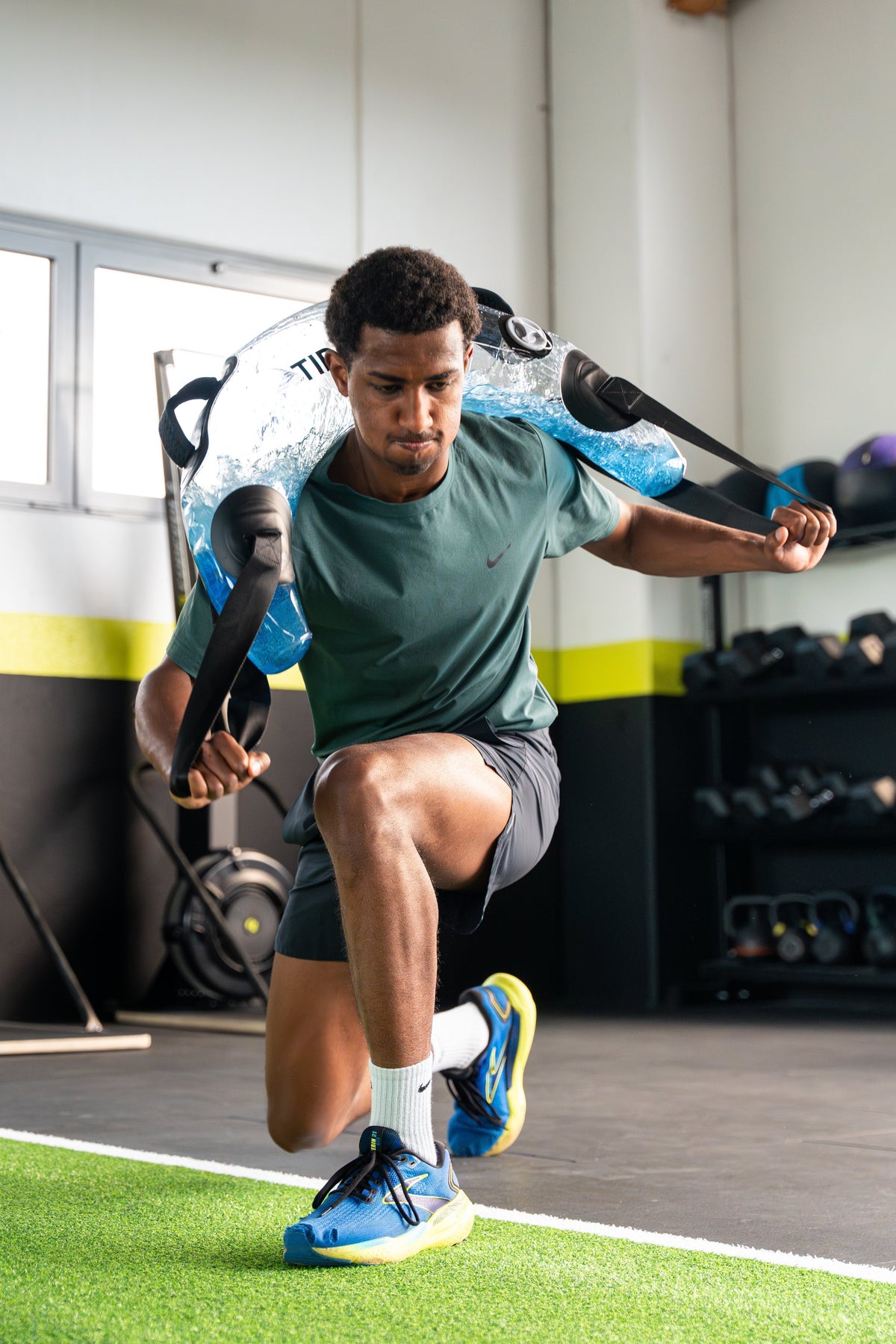 Athlete training rotational strength with the Tidal Tank Bulgarian bag
